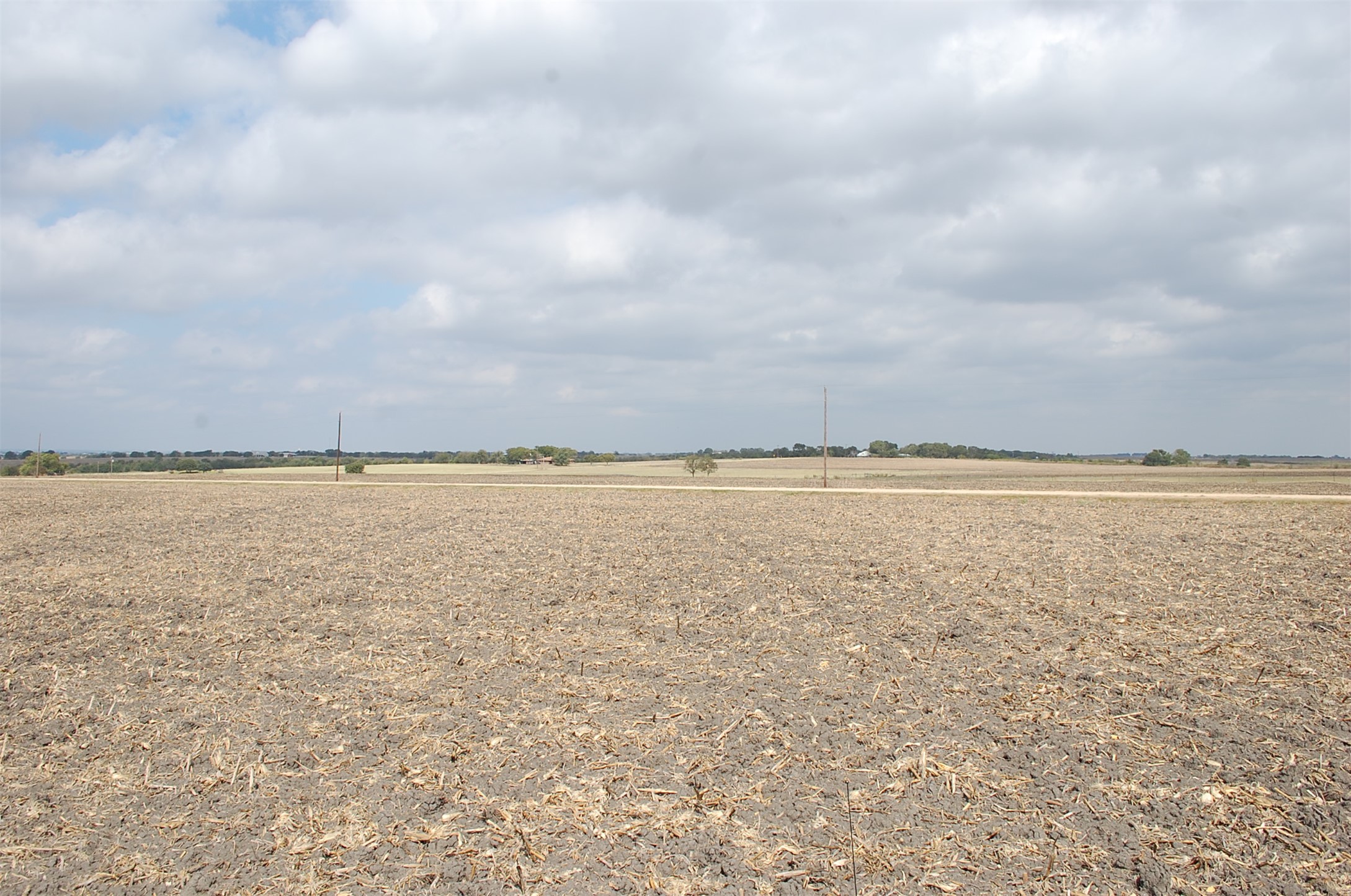 3c Airville Road Temple, TX 76501 - Photo 9 of 12 Level pasture land stretches toward the horizon under expansive skies.