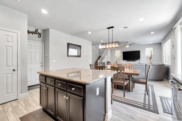 a kitchen with a table chairs and a fireplace