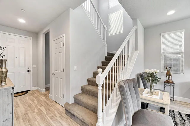 a view of entryway and hall with wooden floor