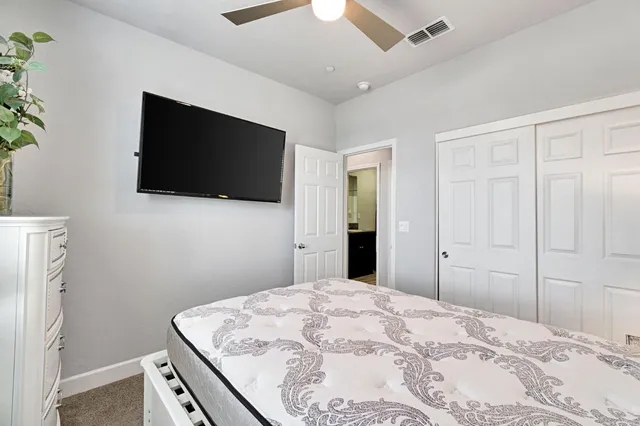 a bedroom with a bed and a flat screen tv