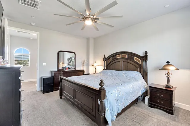 a bedroom with a bed and a chandelier