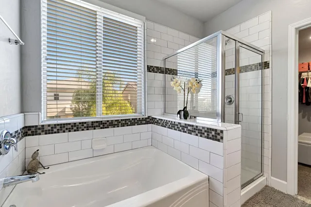 a bathroom with a bathtub and a window