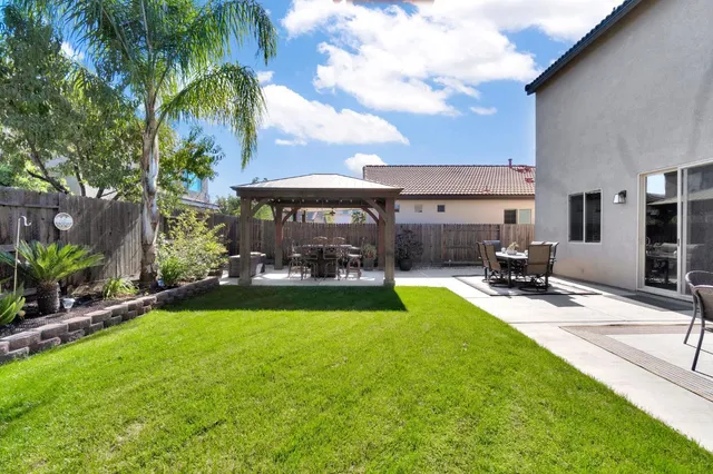 a view of a house with swimming pool and sitting area