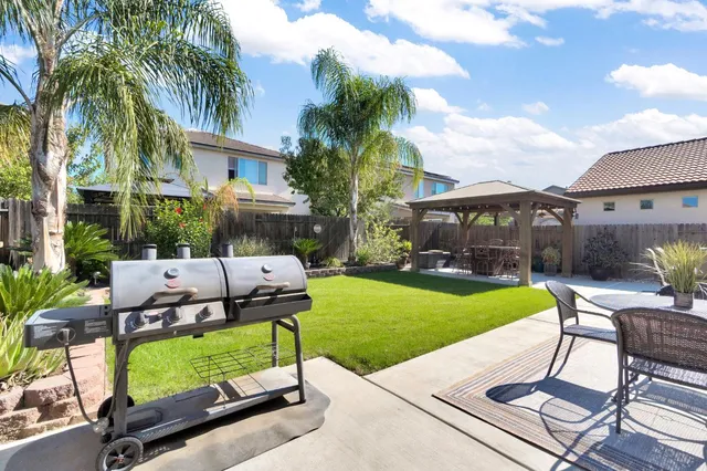 a view of a patio with a table and chairs