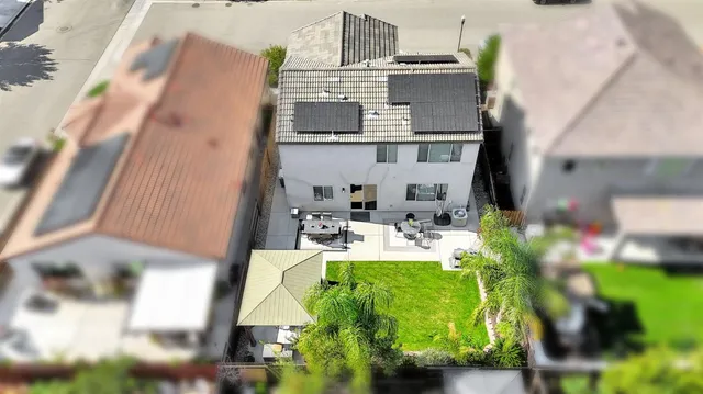 a view of a kitchen with a fireplace in the background