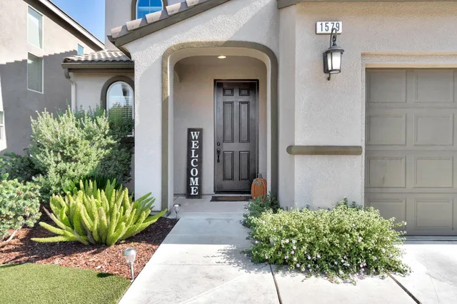 a front view of a house with a yard