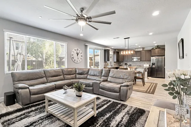 a living room with furniture a large window and a rug