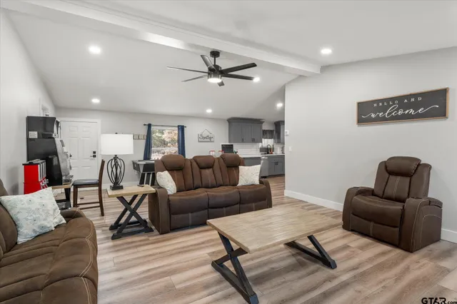 a room with a table chairs and wooden floor