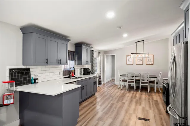 a kitchen with a sink stove and cabinets
