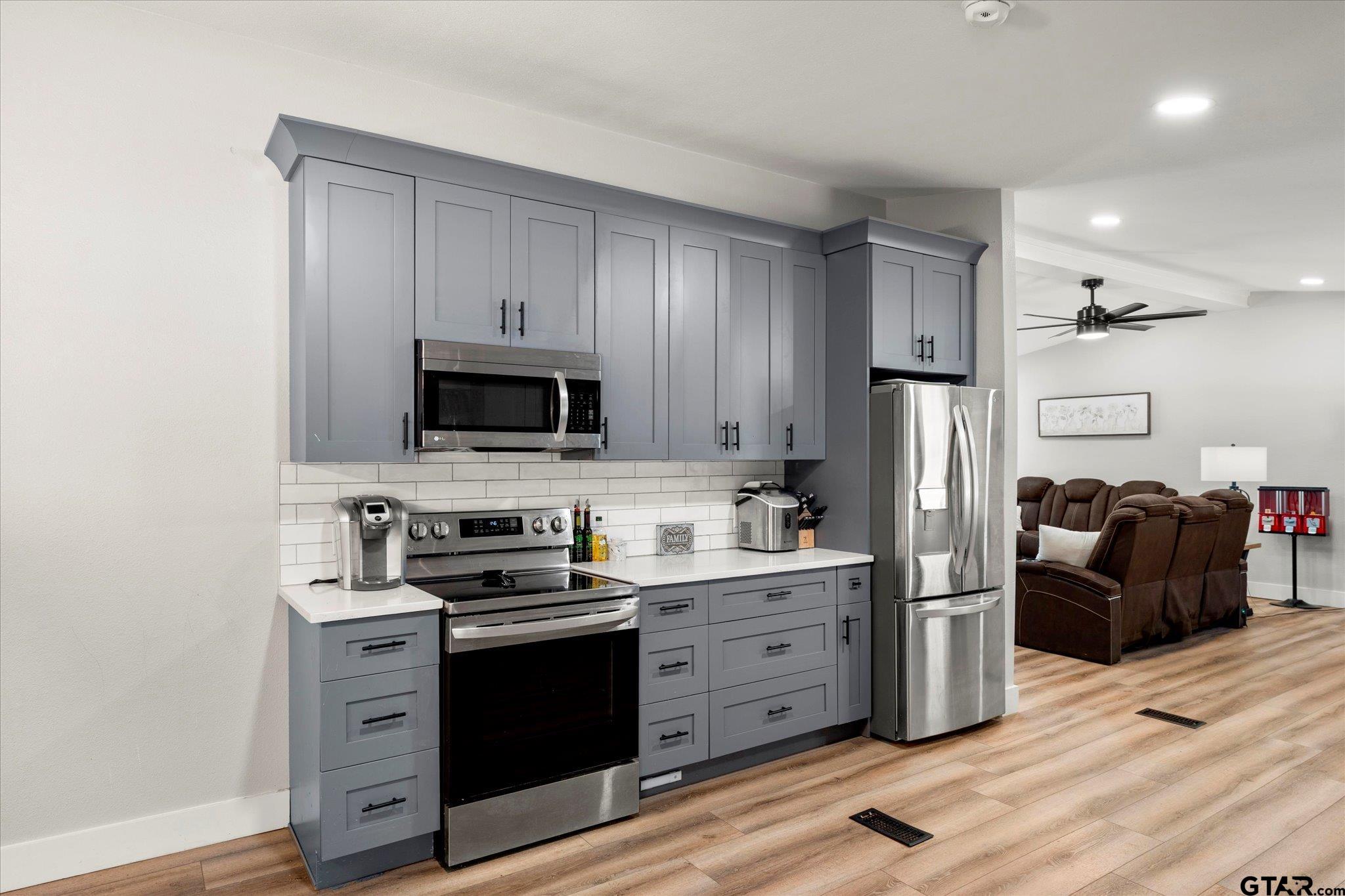 170 Private Road Leesburg, TX 75451 - Photo 28 of 46 a kitchen with stainless steel appliances a stove a sink a refrigerator a microwave and cabinets
