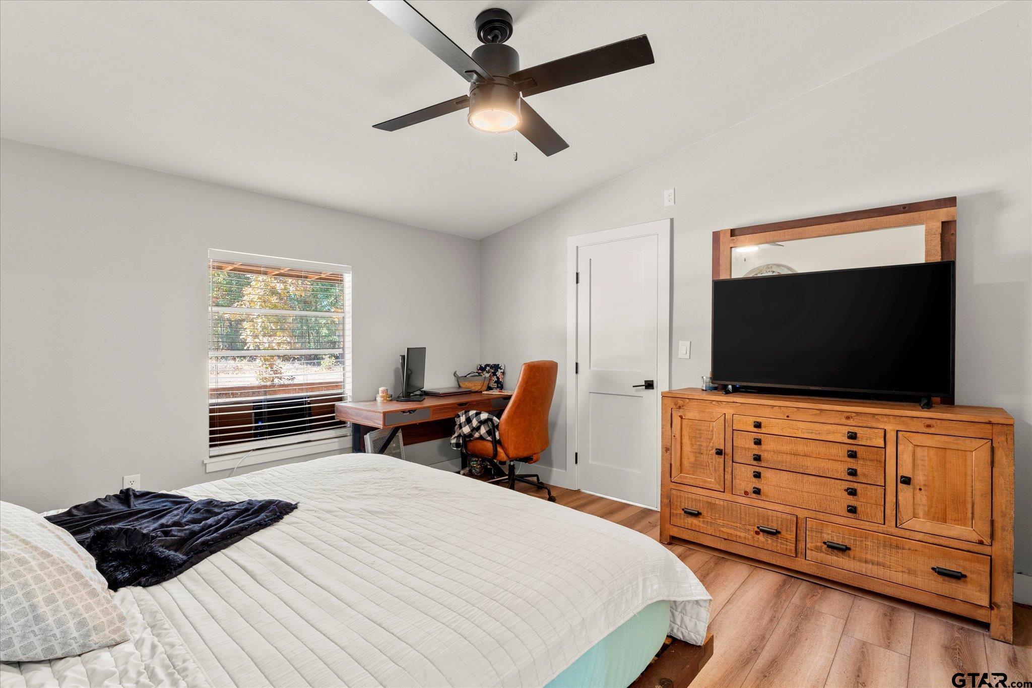 170 Private Road Leesburg, TX 75451 - Photo 31 of 46 a bedroom with a bed and a flat screen tv