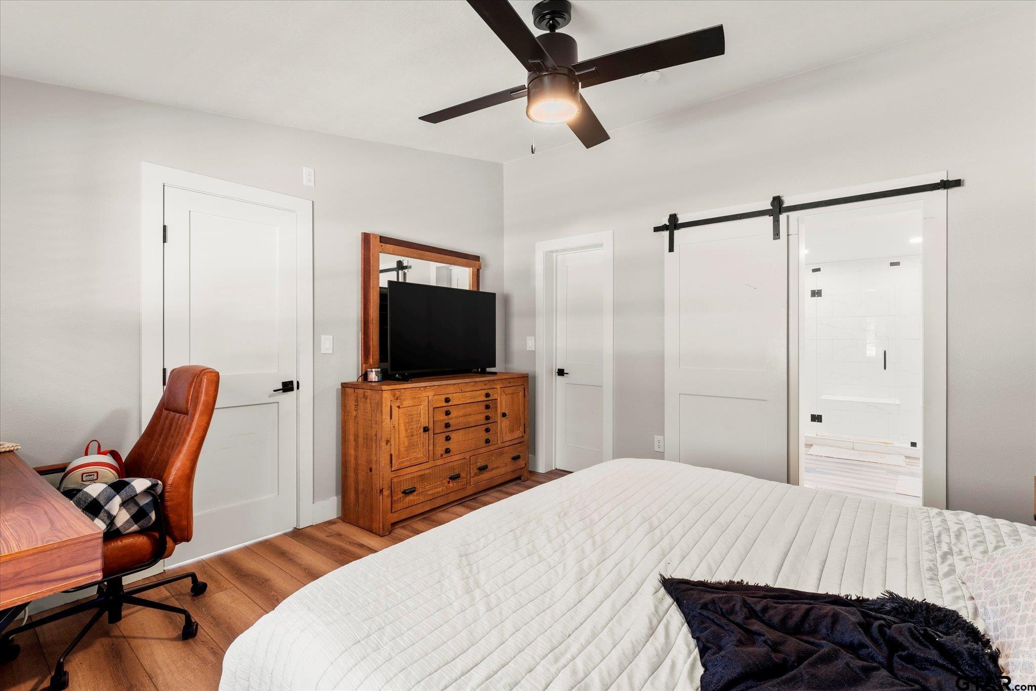 170 Private Road Leesburg, TX 75451 - Photo 34 of 46 a bedroom with a bed and a flat screen tv