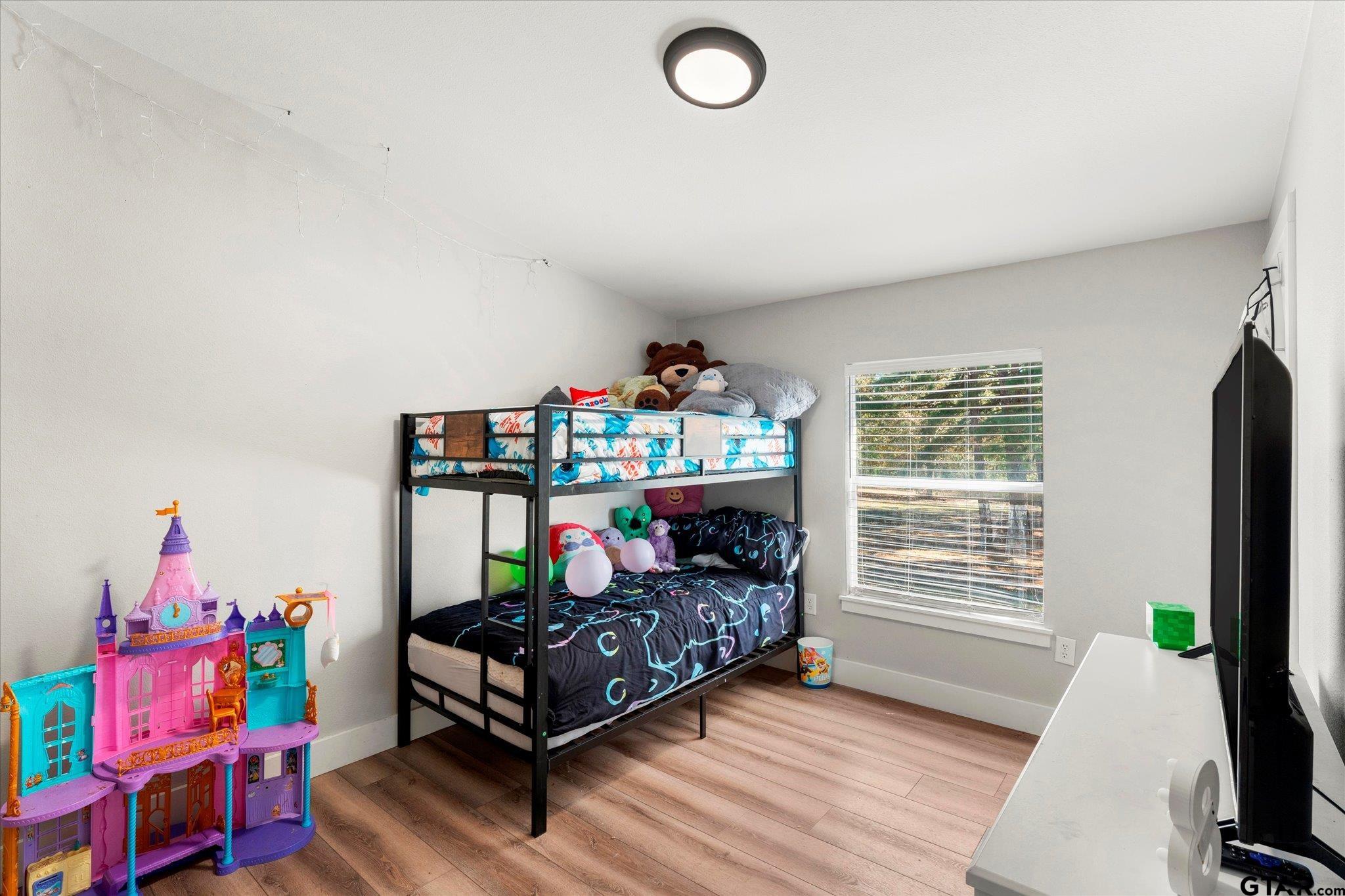 170 Private Road Leesburg, TX 75451 - Photo 39 of 46 a bedroom with furniture and a window