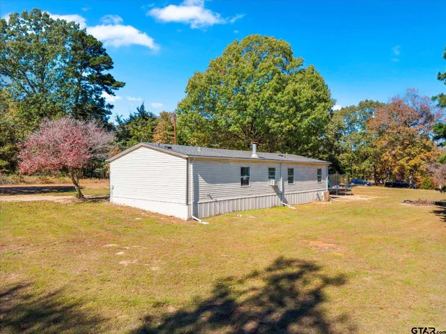 a view of road with large trees