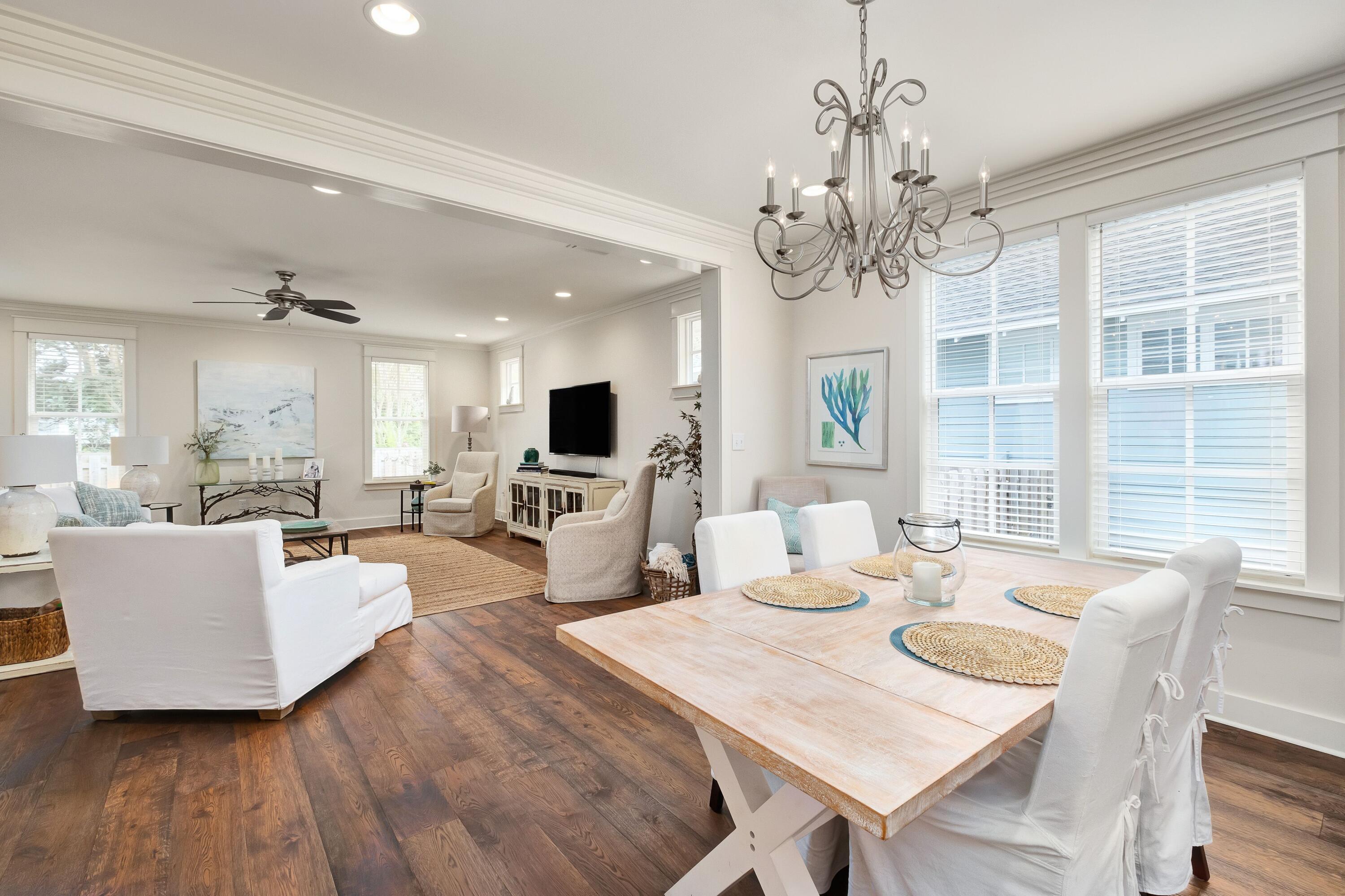 41 Carson Court Miramar Beach, FL 32550 - Photo 4 of 67 a living room with furniture a chandelier and wooden floor