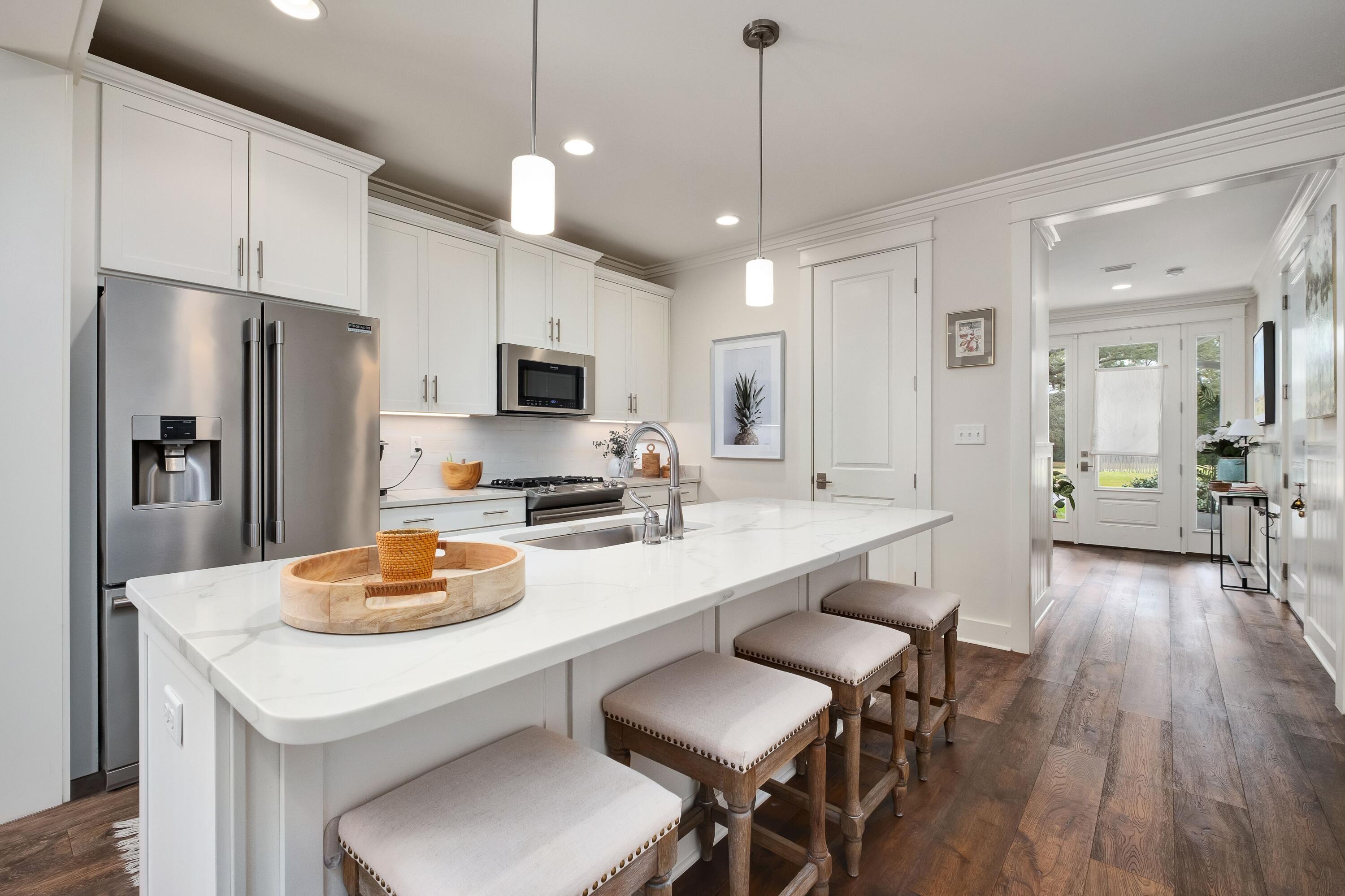 41 Carson Court Miramar Beach, FL 32550 - Photo 10 of 67 a kitchen with a dining table chairs refrigerator and microwave