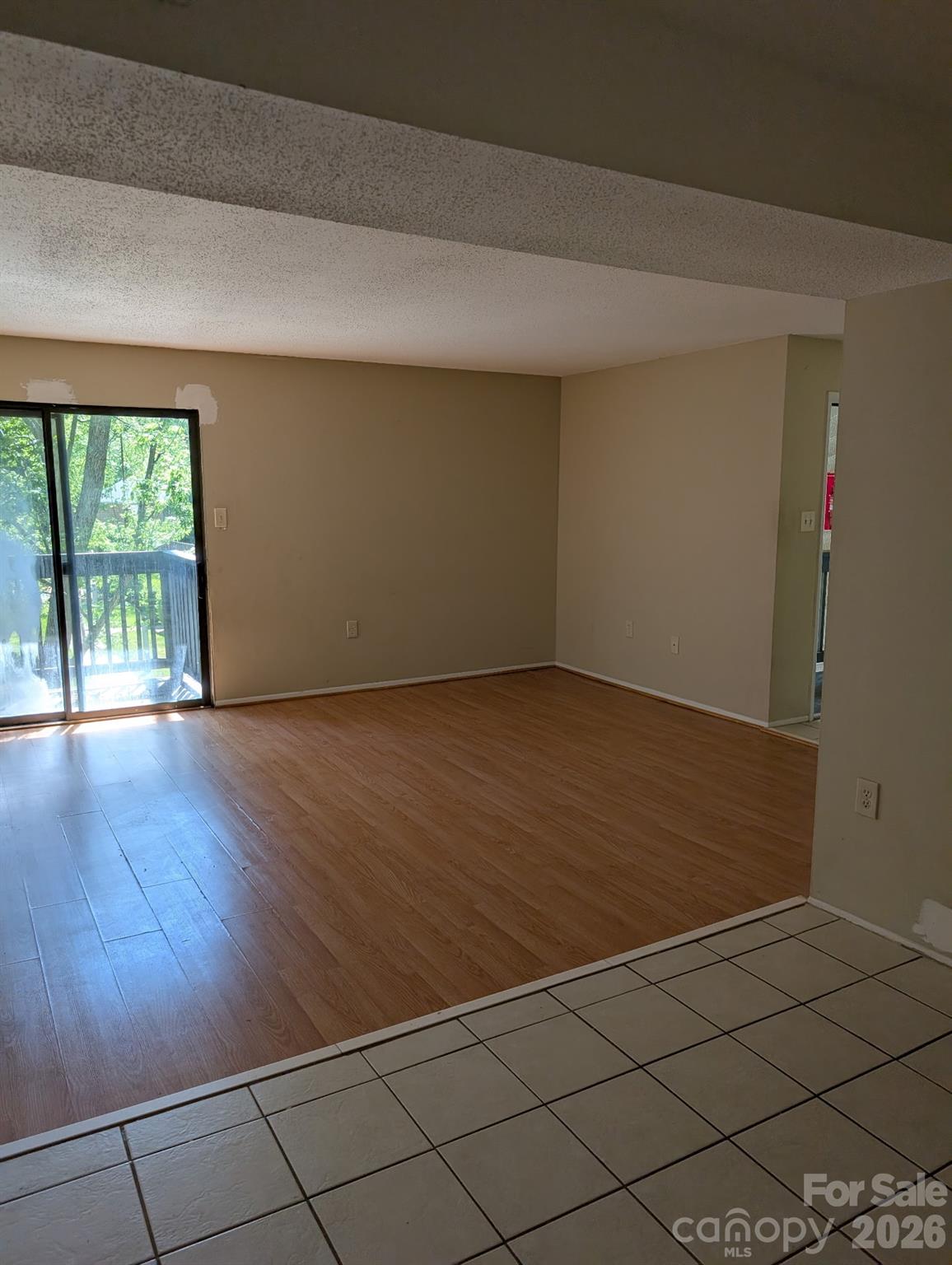 5012 Sardis Road, Unit D Charlotte, NC 28270 - Photo 7 of 12 an empty room with wooden floor and windows