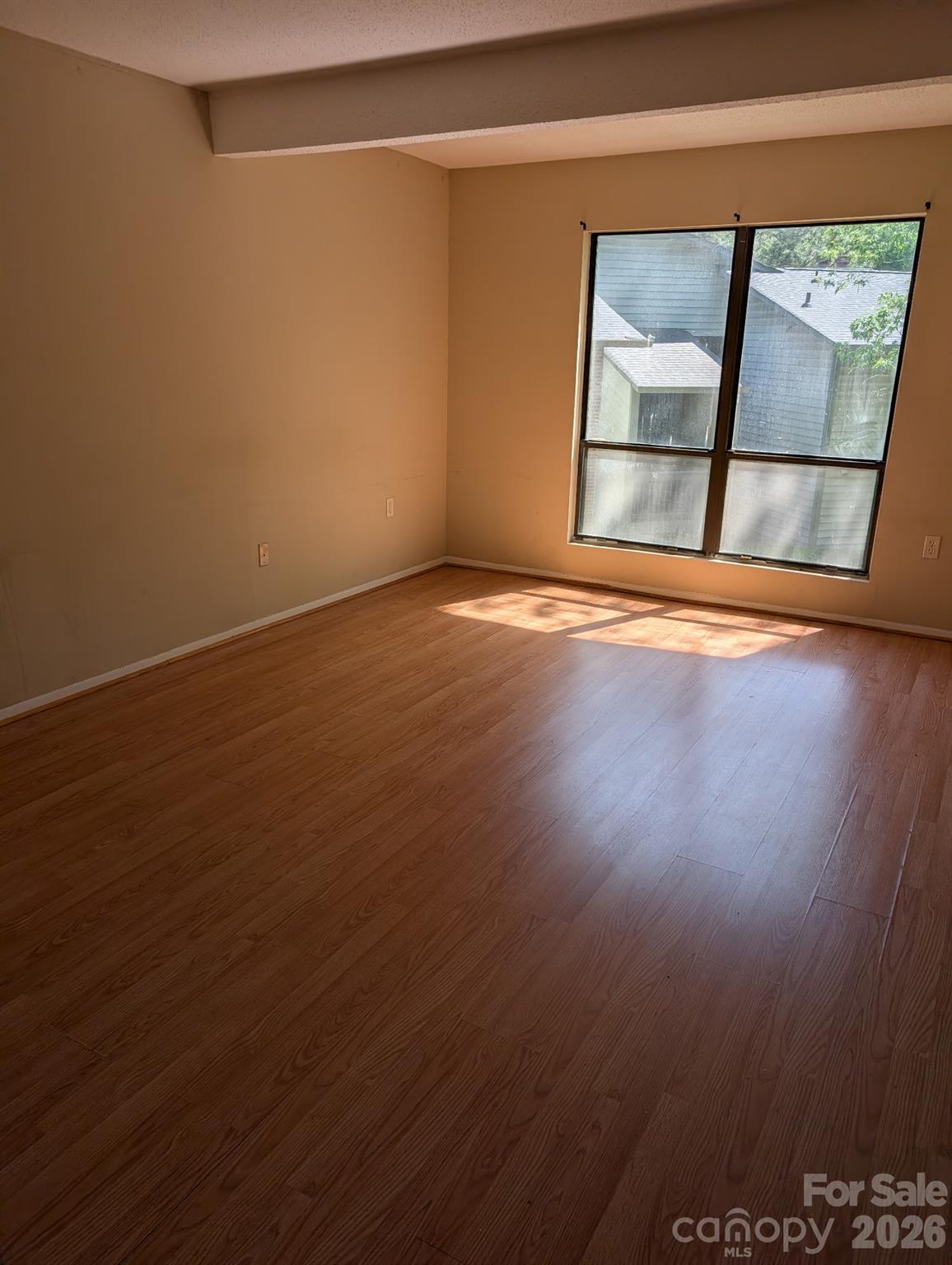 5012 Sardis Road, Unit D Charlotte, NC 28270 - Photo 8 of 12 an empty room with wooden floor and windows