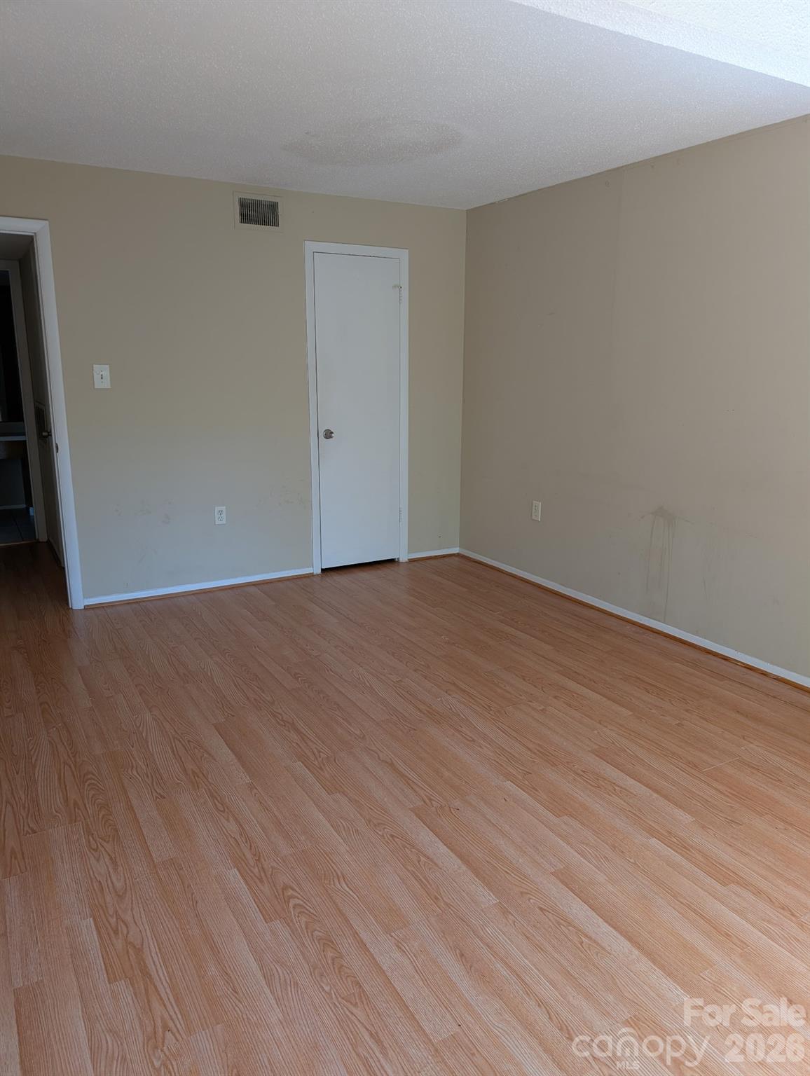5012 Sardis Road, Unit D Charlotte, NC 28270 - Photo 9 of 12 a view of an empty room with wooden floor and a window