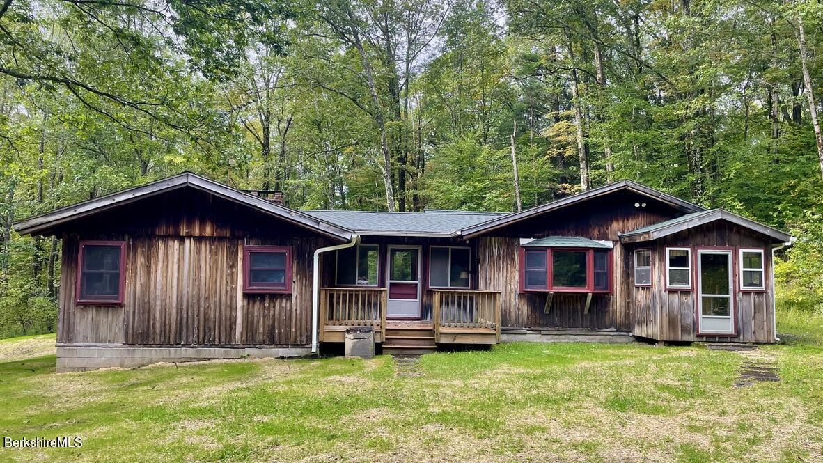 309 Main Road Tyringham, MA 01264 - Photo 1 of 21 a front view of a house with yard