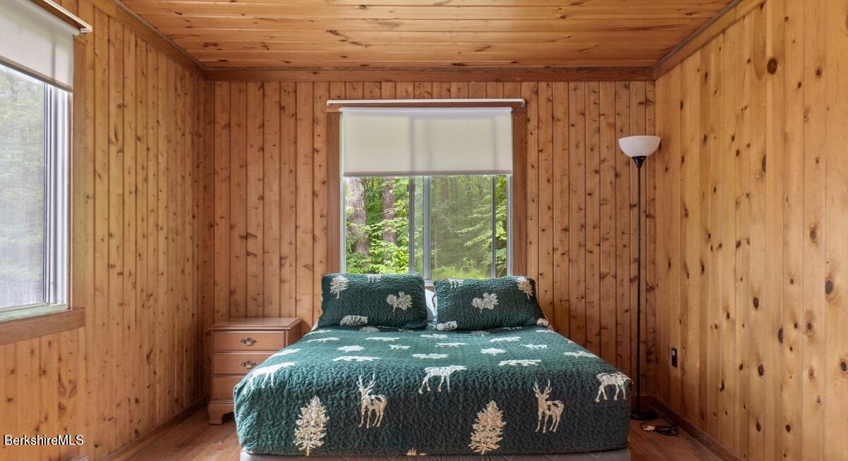309 Main Road Tyringham, MA 01264 - Photo 8 of 21 a bed sitting in a bedroom next to a window