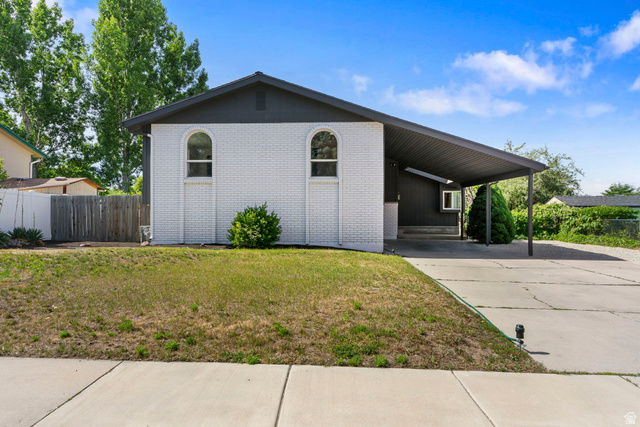 432 Calnette Drive Sandy, UT 84070 - Photo 38 of 48 White brick exterior with a dark gray roofline and integrated carport