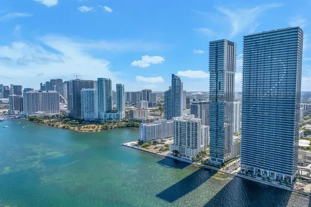 a bedroom with a bed next to a large window with outer view