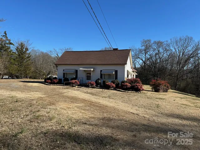 a view of a house with a yard covered in snow