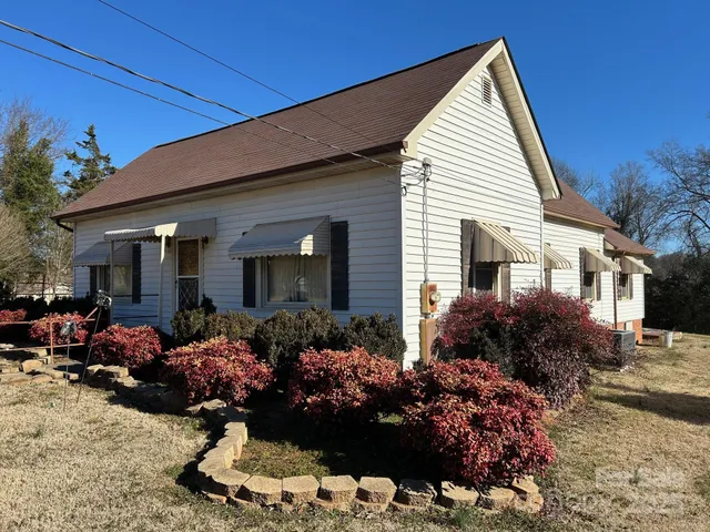 a view of a house with a yard and garden