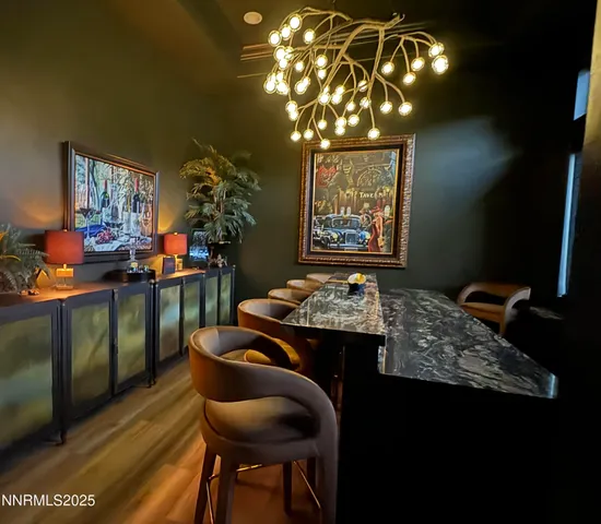 a view of a dining room with furniture and chandelier