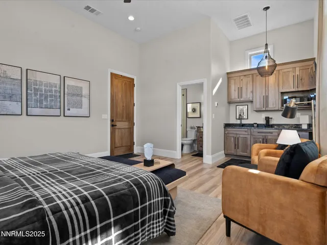a bedroom with a bed couch and window