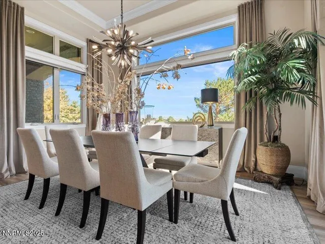 a view of a dining room with furniture and a potted plant