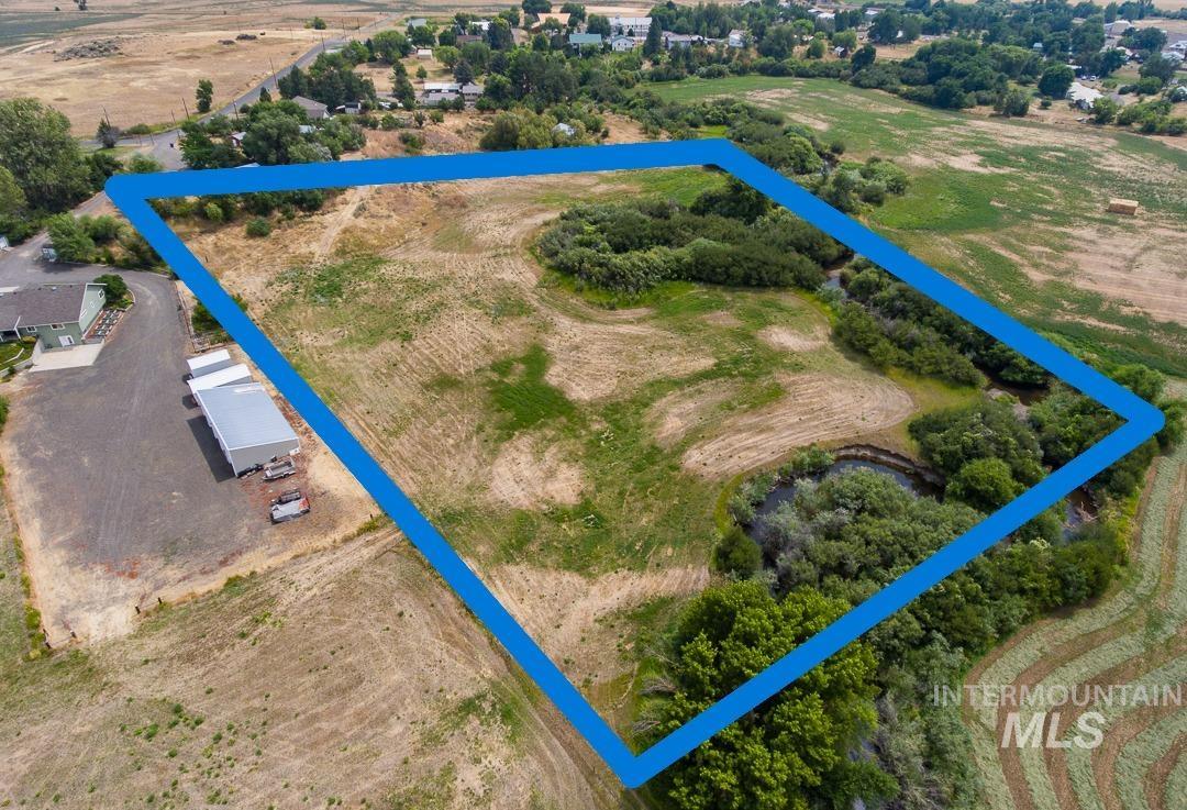 595 Cemetery Road Cambridge, ID 83610 - Photo 46 of 47 Expansive land parcel featuring a mix of open fields, mature trees, and a natural water feature