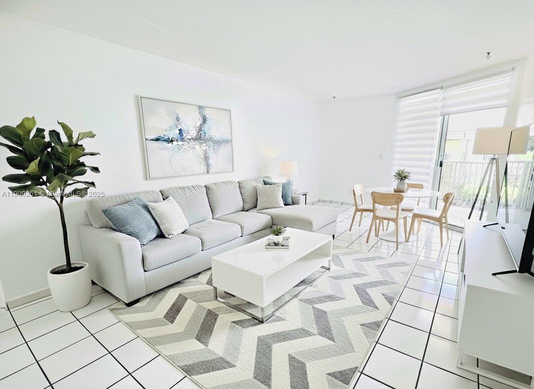 1750 West 46th Street, Unit 535 Hialeah, FL 33012 - Photo 1 of 26 a living room with furniture and a potted plant