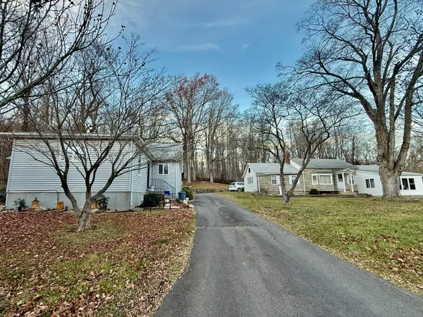a brick house with trees in front of it