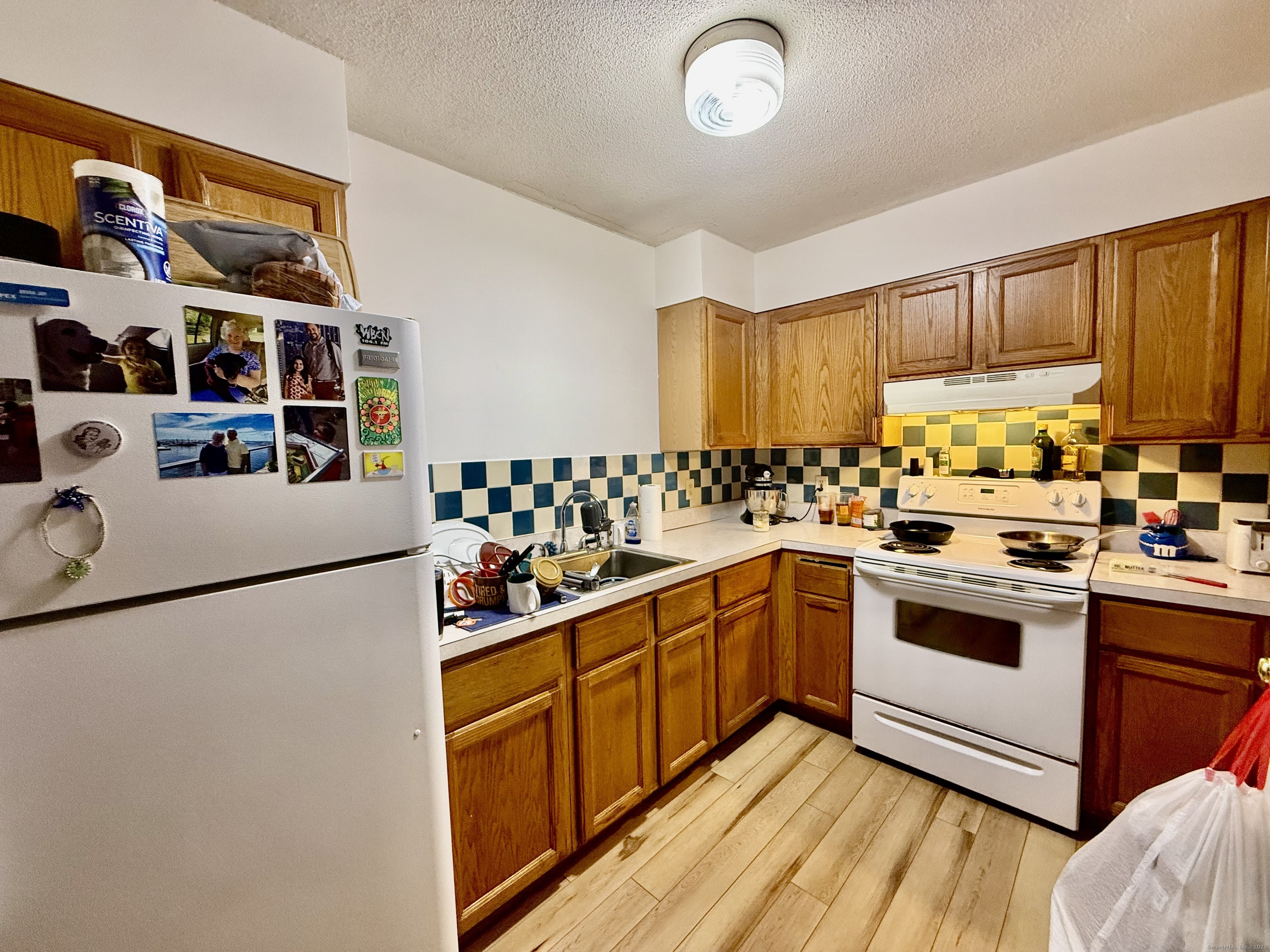 226 West High Street East Hampton, CT 06424 - Photo 11 of 21 a kitchen with stainless steel appliances granite countertop a stove a sink and a refrigerator