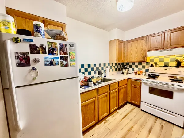 a kitchen with stainless steel appliances a refrigerator and a sink