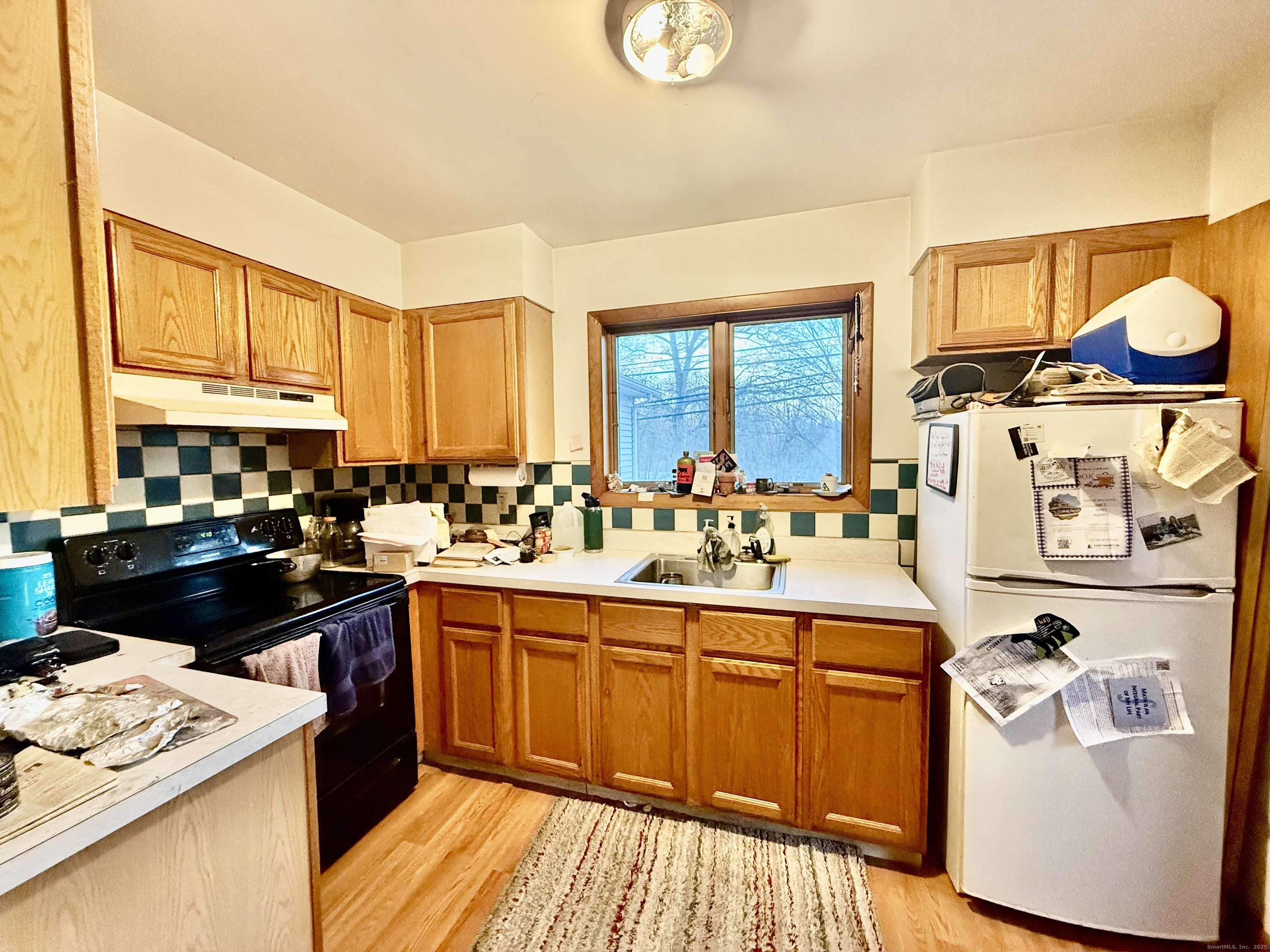 226 West High Street East Hampton, CT 06424 - Photo 14 of 21 a kitchen with a sink stove and cabinets