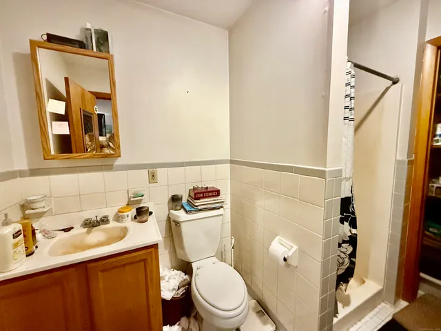 a white toilet sitting next to a bathroom sink
