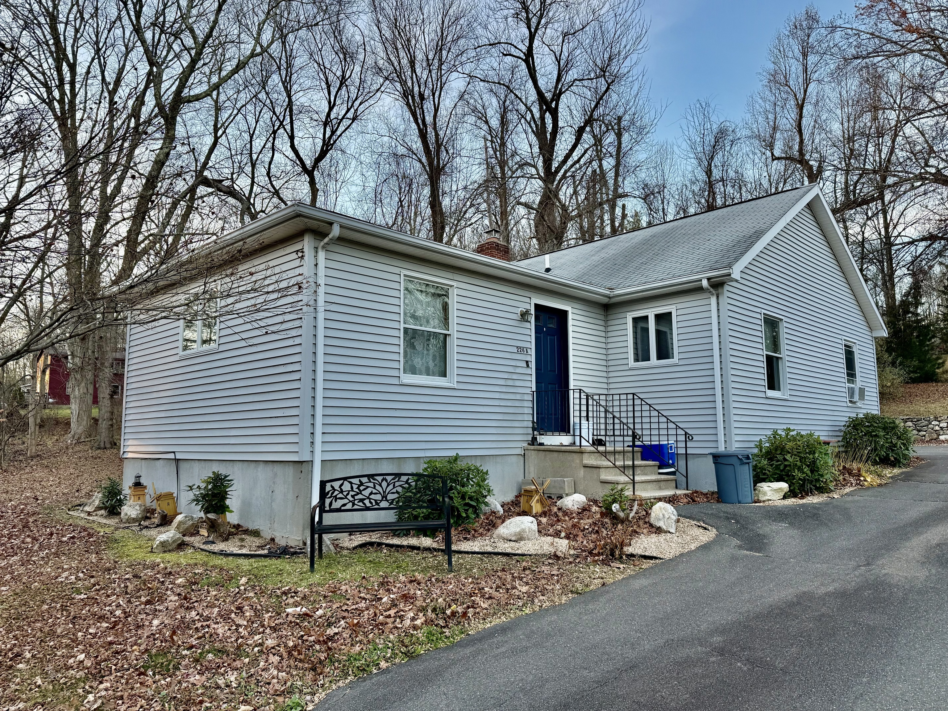 226 West High Street East Hampton, CT 06424 - Photo 3 of 21 a backyard of a house with flower plants and chairs