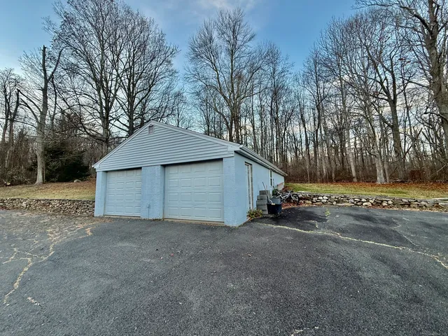 a view of a house with a yard and garage