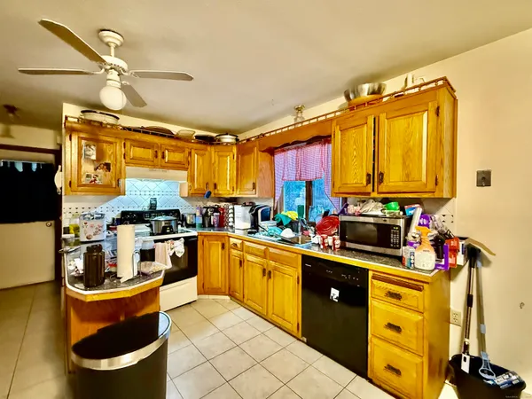 a kitchen that has a lot of cabinets in it