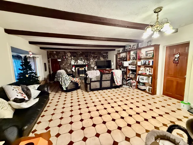 a living room with furniture and a chandelier