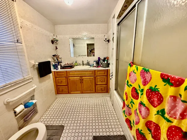 a large bedroom with a bed and furniture