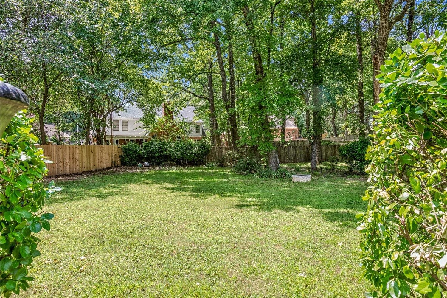 65 Summer Grove Road Memphis, TN 38018 - Photo 38 of 38 Expansive backyard featuring a large grassy area, mature trees, and privacy fencing