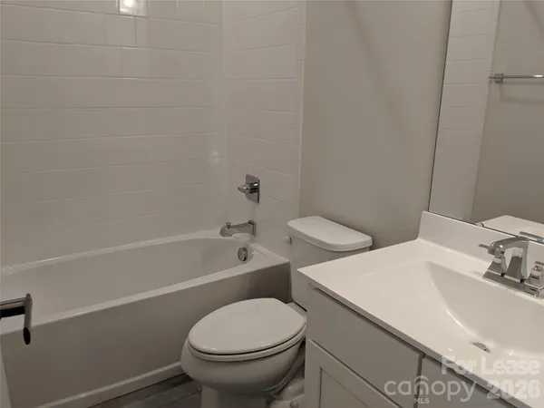 a bathroom with a sink a toilet and bathtub