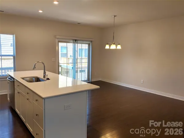 a kitchen that has a sink a stove and a window