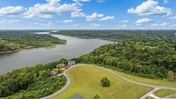 an aerial view of a house with a lake view