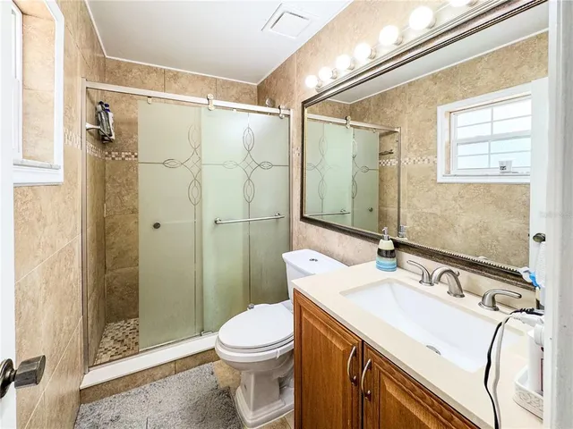 a living room with furniture a large window and a chandelier