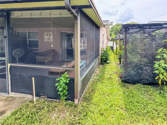 a view of a house with backyard and porch